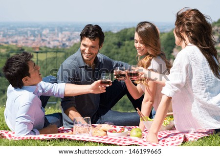 Happy Young Friends Toasting Wine Glass