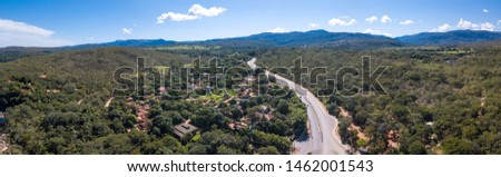Beautiful aerial view of Serra do Cipo in Minas Gerais with forests, rivers and mountains, houses and hotels in sunny summer day with blue sky. Brazilian Cerrado landscape, famous tourist destination.
