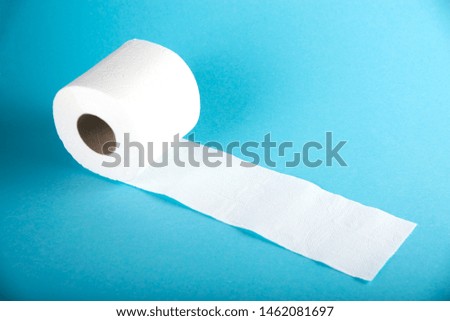 A roll of white toilet paper on a colored background.