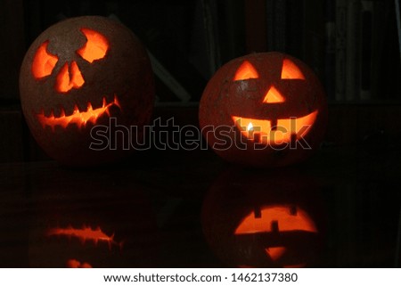 two pumpkins shine on a halloween