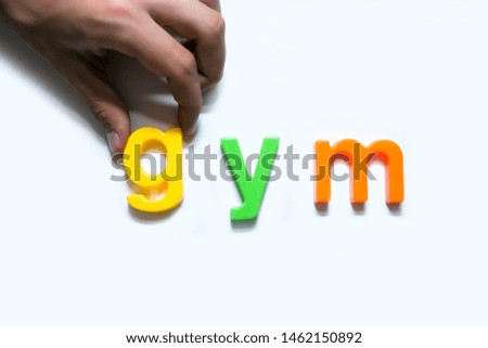 multicolored plastic letters laid out on a white background and composed into words