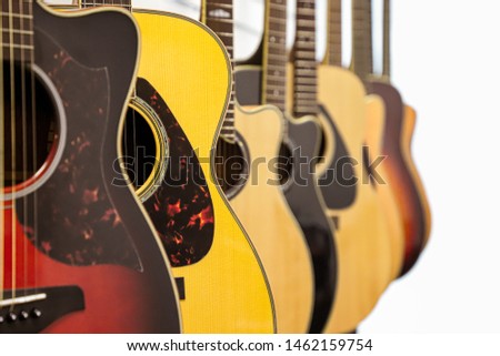 Several Acoustic Guitars Hanging strings music sunburst