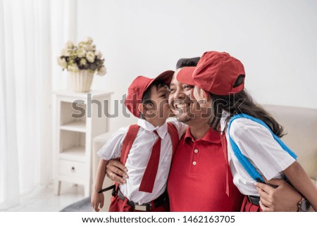 lovely son and daughter kiss father on cheek before going to school