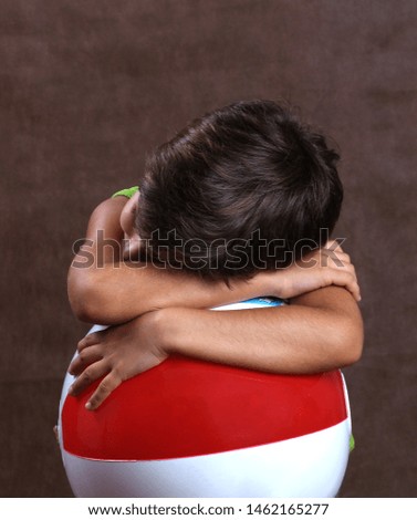 Child hugged in a ball resting.