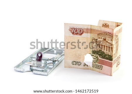 Hole in the budget. Bank note with a hole on a white background. Nearby is a metal mousetrap
