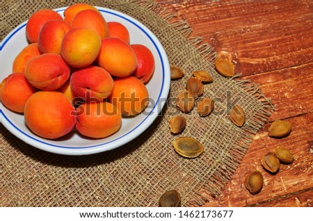 Ripe apricots in a bowl with stones.