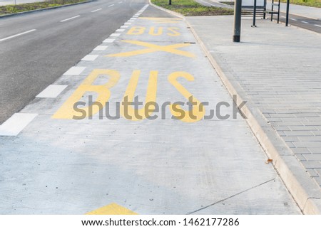 Yellow marks for BUS station stop painted on the street in the city