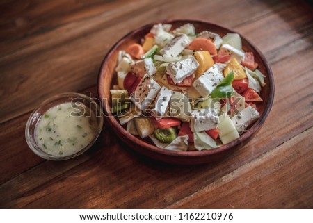 Greek salad on a bowl with feta cheese