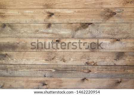 Old brown wood background made of dark natural wood in grunge style. The view from the top. Natural raw planed texture of coniferous pine. The surface of the table to shoot flat lay. Copy space