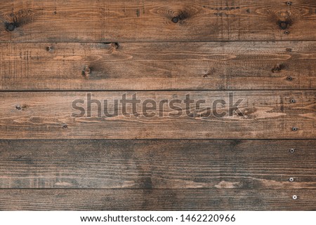 Old brown wood background made of dark natural wood in grunge style. The view from the top. Natural raw planed texture of coniferous pine. The surface of the table to shoot flat lay. Copy space Royalty-Free Stock Photo #1462220966