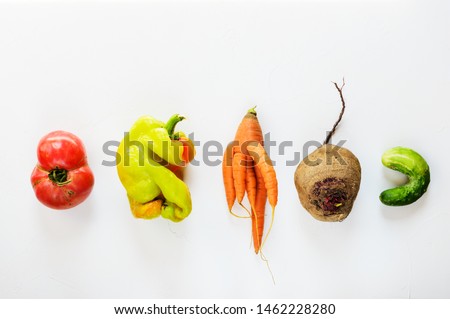 Ugly vegetables on a white background. Ugly food concept, flat lay. Royalty-Free Stock Photo #1462228280