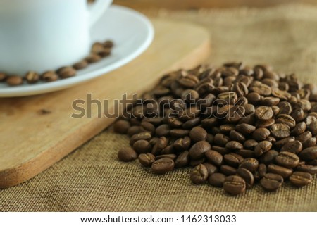 Freshly roasted coffee beans are ready to be grinded to cook a delicious coffee.