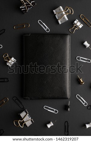 Flat lay, black style. Layout with black cover for design, Set of stationery accessories on black background. Design