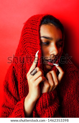 young pretty indian girl in red sweater posing emotional, fashion hipster teenage, lifestyle people concept close up