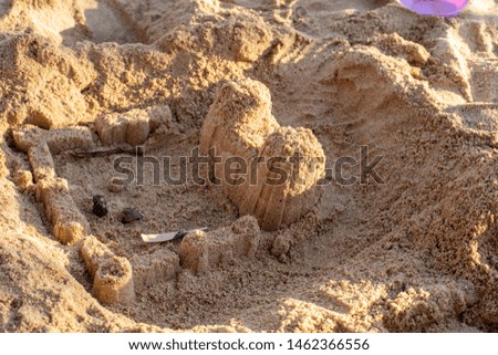 Square sand castle, made by children on the beach, side view