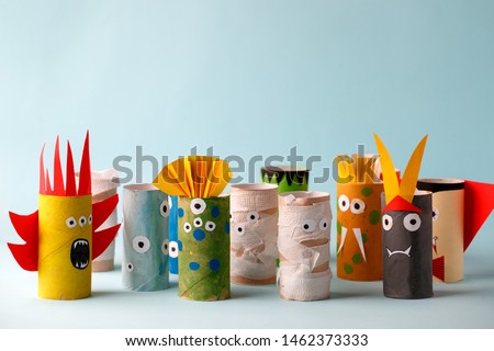 Coronavirus COVID-19 disease 2020 paper toy ghost, bat, monsters for Halloween party. Easy crafts for kids on blue background, copy space, die creative idea from toilet tube, recycle concept Royalty-Free Stock Photo #1462373333