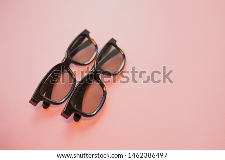 3D cinema, glasses for cinema on a pink background. Free space for text