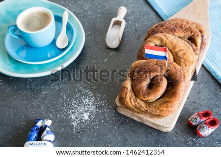 cup of coffee with typical Dutch cinnamon roll cake called Zeeuwse Bolus. Royalty-Free Stock Photo #1462412354