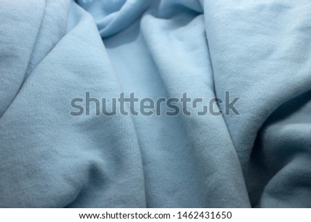 This is a photograph of Light Blue textured fabric background