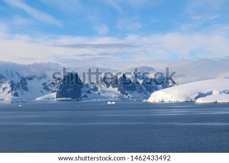 Snow-capped mountains and icy shores of the Bismarck Strait in the Antarctic Peninsula, Antarctica