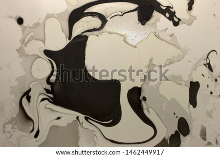 This is a photograph of a Black,Gray and White abstract marbleized background created using nail polish
