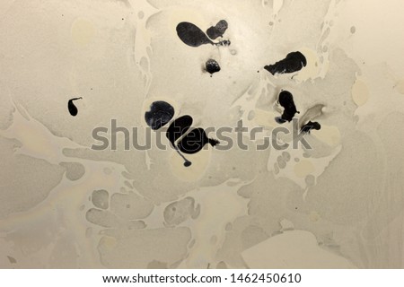 This is a photograph of a Black, Gray and White abstract background created using nail polish