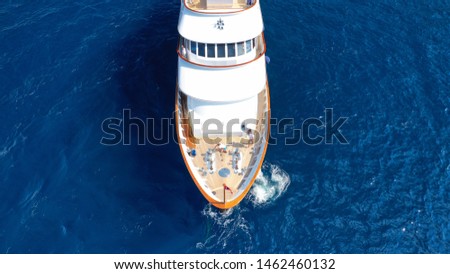 Aerial top view photo of luxury yacht docked in Mediterranean deep blue sea