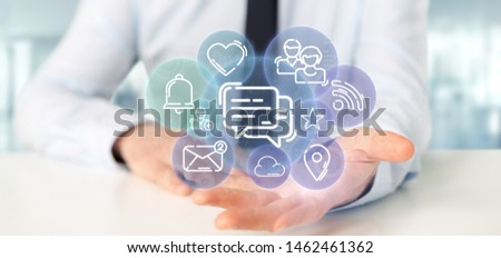 View of a Businessman holding a cloud of social media network icon