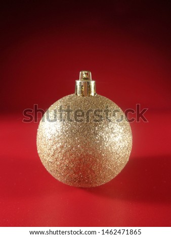 Gold Christmas ball with red background