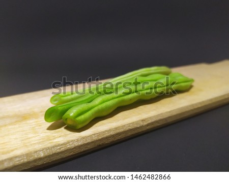 bean on a wooden mat with a black background