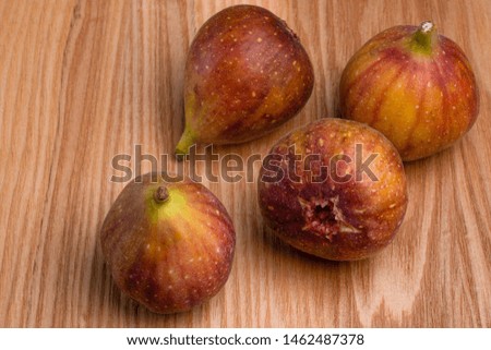 I took a picture of figs on a wooden board.