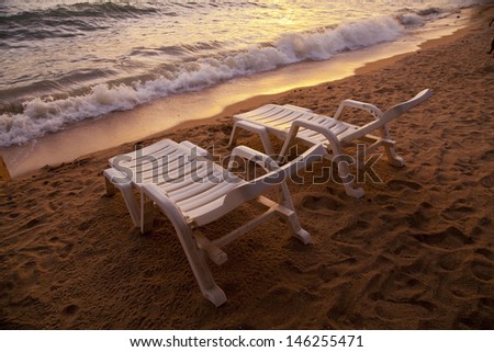 sunset over sea Pataya beach Thailand with beach chair