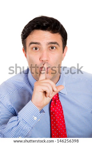 Closeup portrait of handsome businessman making shhh sign with finger on lips, isolated on white background with copy space