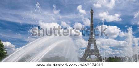 Eiffel tower in Paris by day. Clouds sky