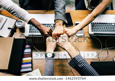 Team in work fist bumping. Royalty-Free Stock Photo #1462593764