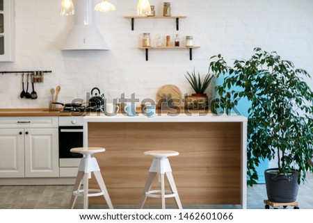Luxurious white kitchen and living room in a big house Royalty-Free Stock Photo #1462601066
