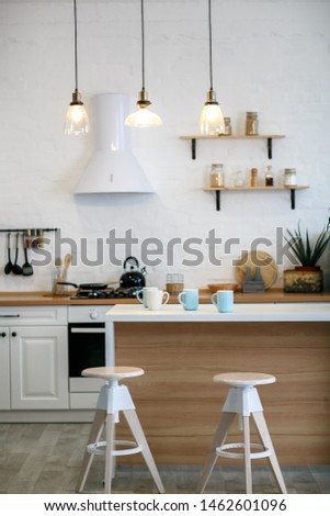 Luxurious white kitchen and living room in a big house Royalty-Free Stock Photo #1462601096