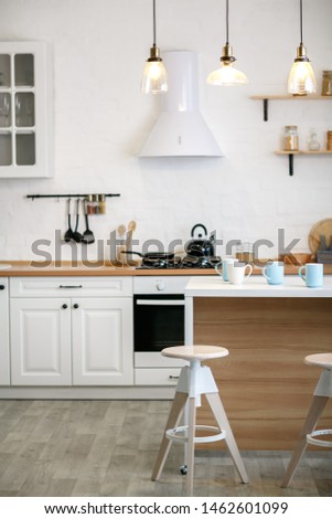 Luxurious white kitchen and living room in a big house Royalty-Free Stock Photo #1462601099