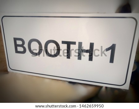 signpost acrylic brand that reads "BOOTH 1" to display in the production room of an office