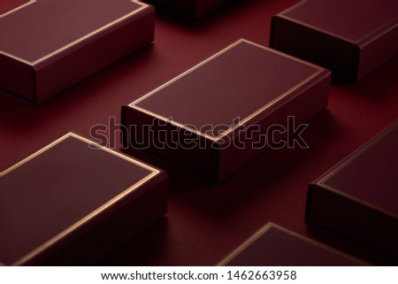 Red gift boxes with gold border on red paper background