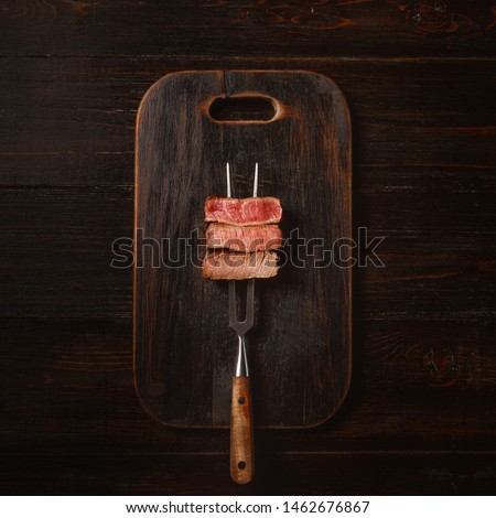 Three pieces of meat on a fork for meat. three types of meat roasting, rare, medium,well done.  Royalty-Free Stock Photo #1462676867