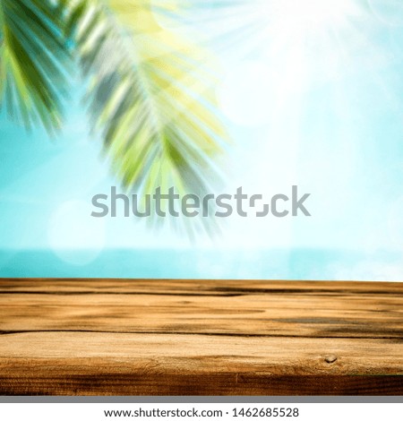 Wooden desk of free space for your decoration and summer background of beach. 