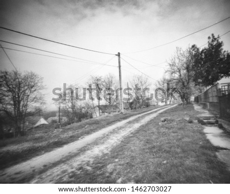small road in a rural area, this black and white camera obscura photo is NOT sharp due to camera characteristic. Taken on analogue photographic large format negative film with a pinhole camera