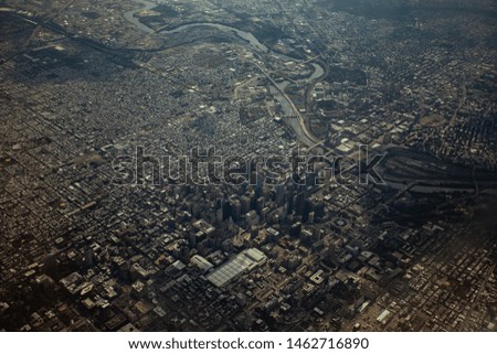 Overhead view of Philadelphia, PA, with skyscrapers and the river that flows through the city.
