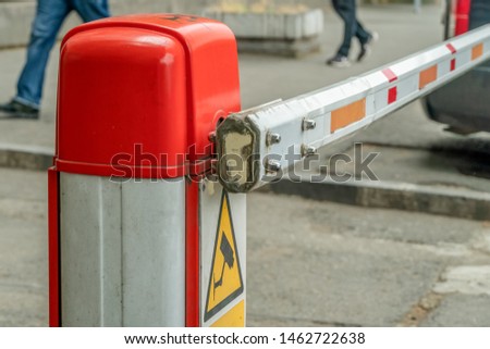 automatic red-white barrier in the yard close-up during daylight hours