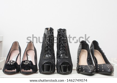 High heeled shoes on wooden shelf