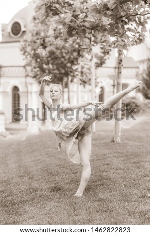 Young ballerina dancing in city streets, feeling breath of big city life and freedom