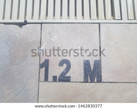 one point two meters sign and drain and water at side of pool