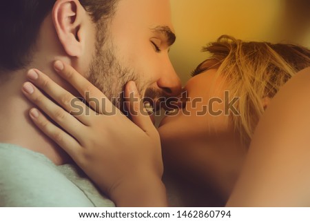 loving couple kissing on the bed.happy couple lying together in the bed. Royalty-Free Stock Photo #1462860794