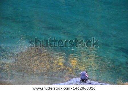 Photography of a man fishing in a lake
